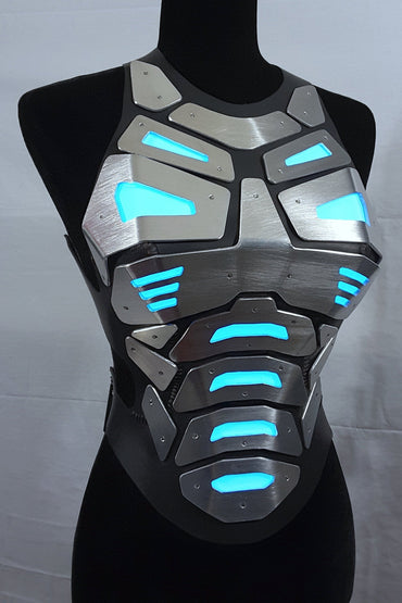 Mannequin wearing futuristic torso armor in silver and black with glowing blue lights