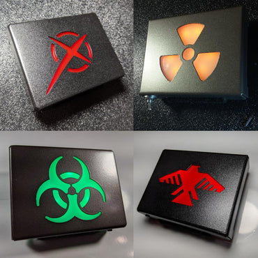 Various glowing metal belt buckles with different symbols