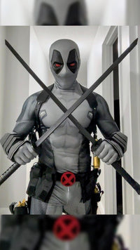 A person wearing a full Deadpool costume standing indoors The costume includes metal shin guards and full protective metal gauntlets