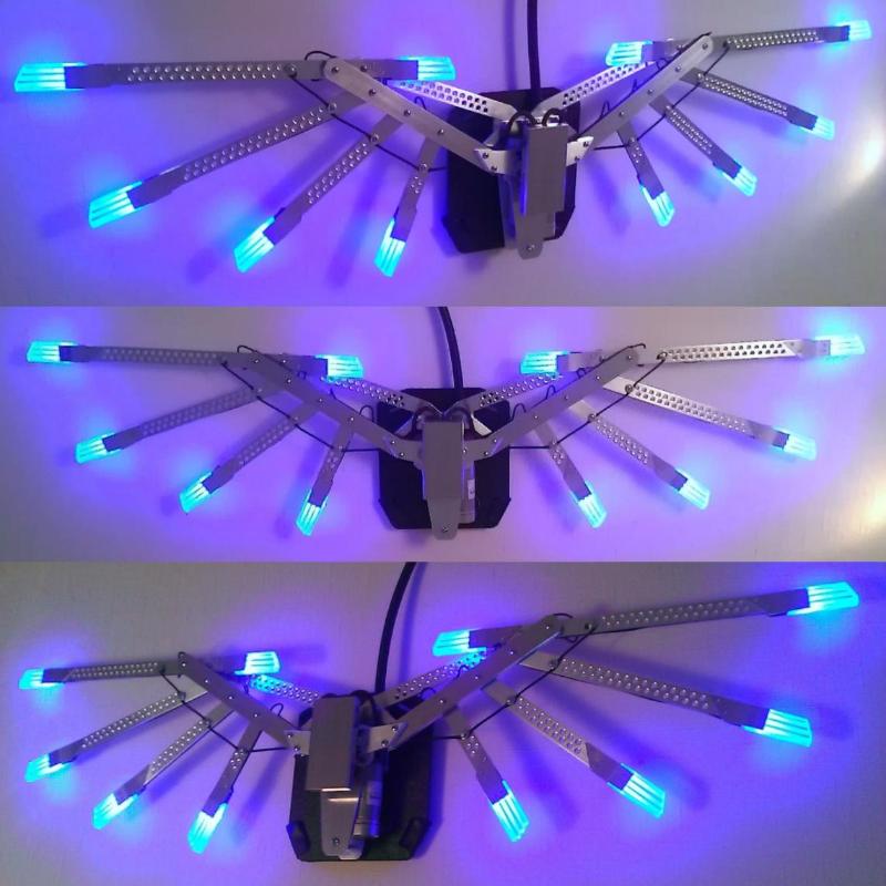 glowing working mechanical wings made of metal