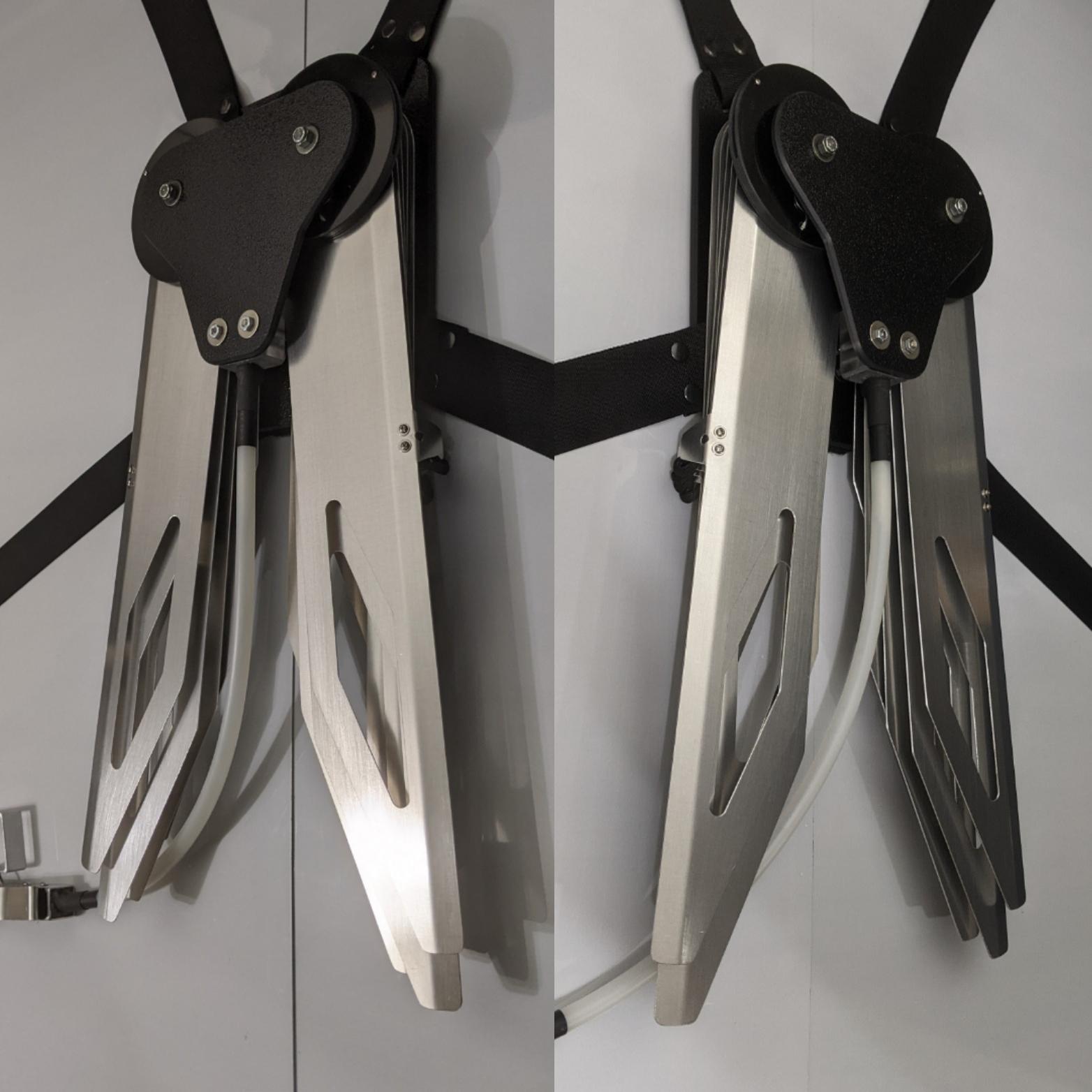 Costume black and silver metal mechanical wings that open and close with a pull cord